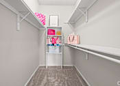 Thumbnail 8 of 38 - A white shelf with a pink bag and a white box on it.