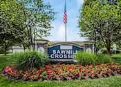 Thumbnail 25 of 28 - A sign that says Sawmill Crossing is in front of a building.