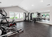 Thumbnail 15 of 28 - A spacious home gym with a variety of exercise equipment.