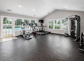 Thumbnail 16 of 28 - A spacious home gym with a variety of exercise equipment.