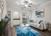 Thumbnail 1 of 38 - A living room with a white couch and a blue rug.