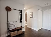 Thumbnail 7 of 26 - A room with a coat rack and a bench.