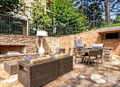 Thumbnail 1 of 32 - A patio with a couch, chairs, and a table.