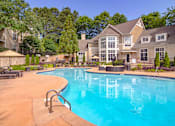 Thumbnail 18 of 32 - A large house with a pool in the backyard.