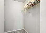 Thumbnail 10 of 39 - A white closet with a shelf and a fan.