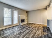 Thumbnail 13 of 20 - A room with a fireplace and wood flooring.