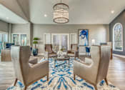Thumbnail 9 of 38 - A living room with a large rug and a chandelier.