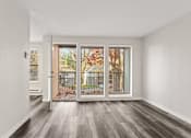 Thumbnail 10 of 24 - A room with a sliding door leading to a balcony.