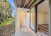 Thumbnail 8 of 24 - A modern house entrance with a wooden door and a glass door.