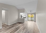 Thumbnail 9 of 23 - A spacious room with a kitchen area and a ceiling fan.