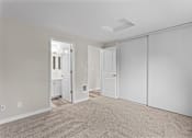 Thumbnail 12 of 23 - A room with a carpeted floor and white walls.