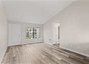 Thumbnail 11 of 23 - A room with wooden flooring and white walls.