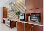 Thumbnail 11 of 32 - A kitchen with a sign that says "Help yourself" on the counter.