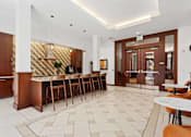 Thumbnail 14 of 32 - A white and wood themed cafe with a bar area.