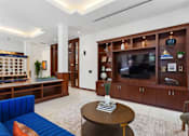 Thumbnail 17 of 32 - A living room with a blue sofa and a wooden coffee table.