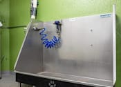 Thumbnail 28 of 32 - A metal table with a blue spring attached to it.