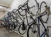 Thumbnail 29 of 32 - A wall of bicycles are parked in a room.
