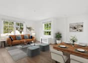 Thumbnail 2 of 32 - A modern living room with a wooden table set for two.