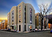 Thumbnail 32 of 32 - A large building with a parking lot in front of it.