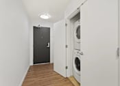 Thumbnail 3 of 32 - A laundry room with a washer and dryer.