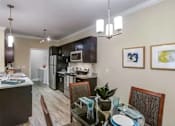 Thumbnail 10 of 31 - A kitchen with a dining table set for two.