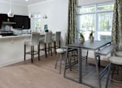 Thumbnail 26 of 31 - A kitchen with a table and chairs.