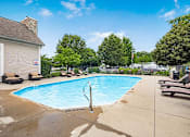 Thumbnail 18 of 28 - A pool with a diving board and a sign that says
