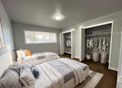 Thumbnail 4 of 21 - A bedroom with two beds and a walk-in closet.