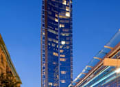 Thumbnail 78 of 78 - A tall building with a blue sky in the background.