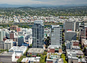 Thumbnail 73 of 78 - A cityscape with a mountain in the background.