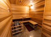 Thumbnail 7 of 40 - a small sauna with two benches and a table at Brookland Apartments, Portland, OR