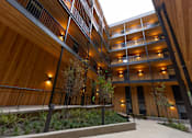 Thumbnail 10 of 40 - A modern building with wooden balconies and railings at Brookland Apartments, Oregon 97202