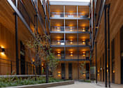 Thumbnail 40 of 40 - a large building with wooden walls and floors and a sidewalk at Brookland Apartments, Portland, 97202