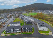 Thumbnail 22 of 46 - Neighborhood of houses on a street with a mountain in the background at Thrive at Green Mountain, Camas, WA, 98607