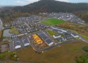 Thumbnail 24 of 46 - an aerial view of a city with a parking lot and buildings at Thrive at Green Mountain, Camas, 98607