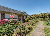 Thumbnail 10 of 13 - A house with a garden in front of it.
