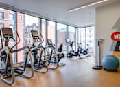 Thumbnail 1 of 78 - A gym with treadmills, exercise bikes and a large ball.