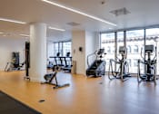 Thumbnail 10 of 78 - A gym with treadmills, elliptical machines, and other exercise equipment.