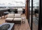 Thumbnail 12 of 19 - a deck on the roof of a building with furniture and a grill at Analog Tacoma, Tacoma