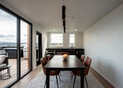 Thumbnail 3 of 19 - a dining room with a table and chairs and sliding glass doors at Analog Tacoma, Tacoma, WA