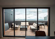 Thumbnail 9 of 19 - a balcony with a city view and a table and chairs at Analog Tacoma, Tacoma, WA