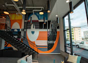 Thumbnail 4 of 19 - a mural in the lobby of a building with a staircase at Analog Tacoma, Tacoma, 98402