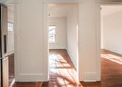 Thumbnail 10 of 28 - A white hallway with sunlight coming through the window at Midtown Apartments, Oregon, 97209