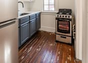 Thumbnail 14 of 28 - A kitchen with a stove and a refrigerator at Midtown Apartments, Portland, Oregon