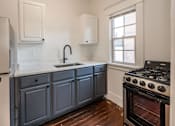 Thumbnail 2 of 28 - A kitchen with a stove and a window at Midtown Apartments, Oregon