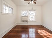 Thumbnail 15 of 28 - A room with a ceiling fan and two windows at Midtown Apartments, Portland
