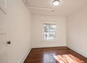 Thumbnail 18 of 28 - A room with a window and a door at Midtown Apartments, Portland, OR, 97209