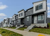 Thumbnail 31 of 46 - Row of houses with a sidewalk in front at Thrive at Green Mountain, Washington  , 98607
