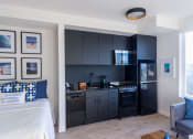 Thumbnail 11 of 16 - Living With Kitchen at Nomad Apartments, Portland, OR, 97217