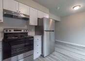 Thumbnail 1 of 18 - a kitchen with a stove and a refrigerator